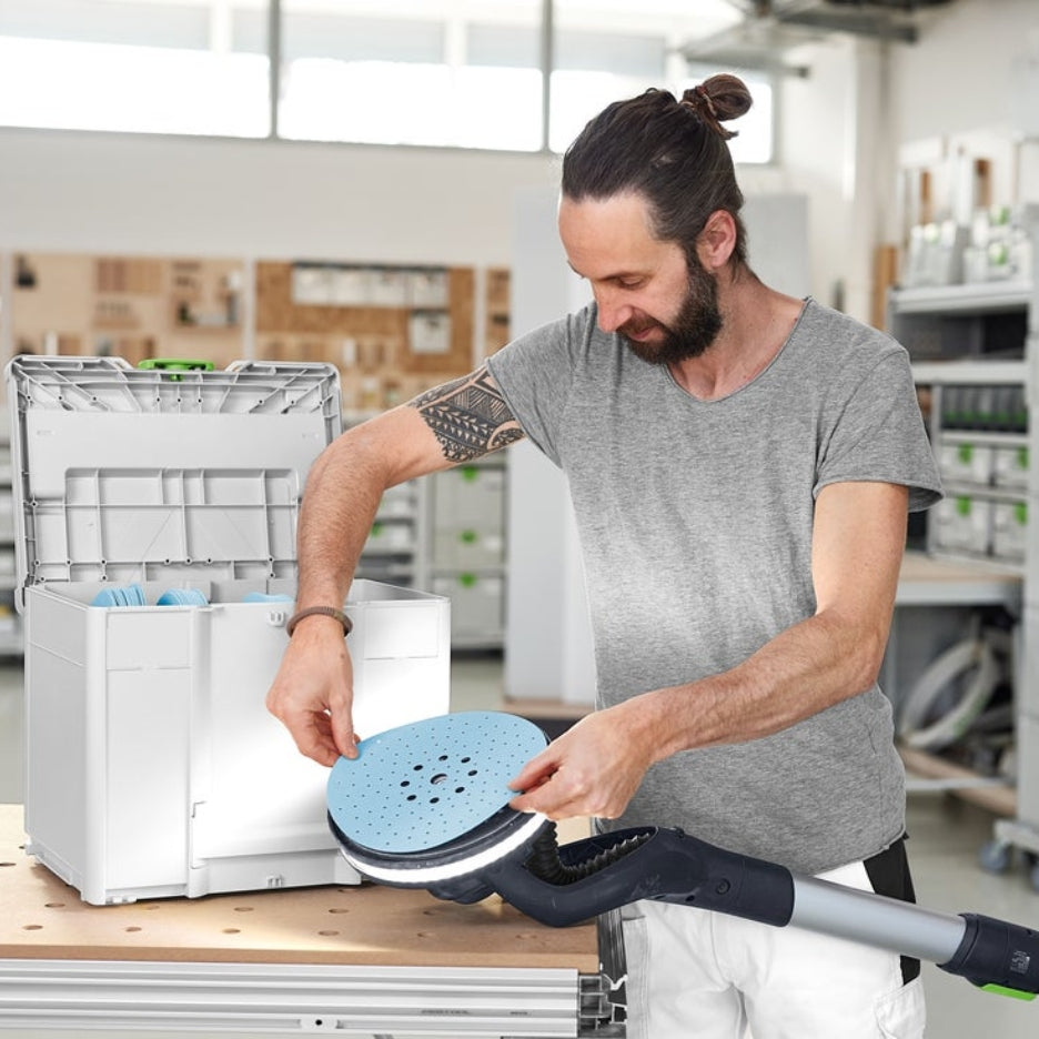 Man placing Granat abrasive on Planex sander