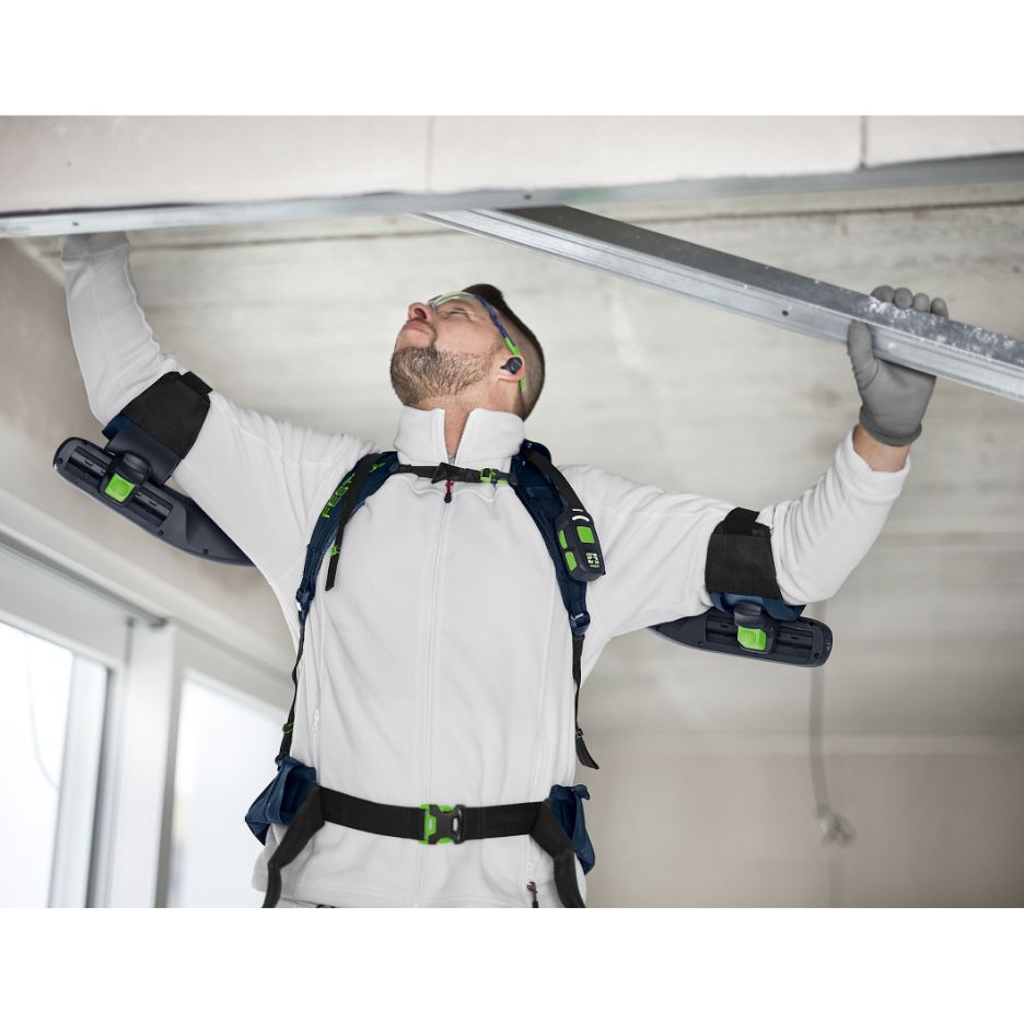 Man wearing Festool Exoskeleton ExoActive EXO 18 HPC 4.0 I-Plus while holding a metal bar