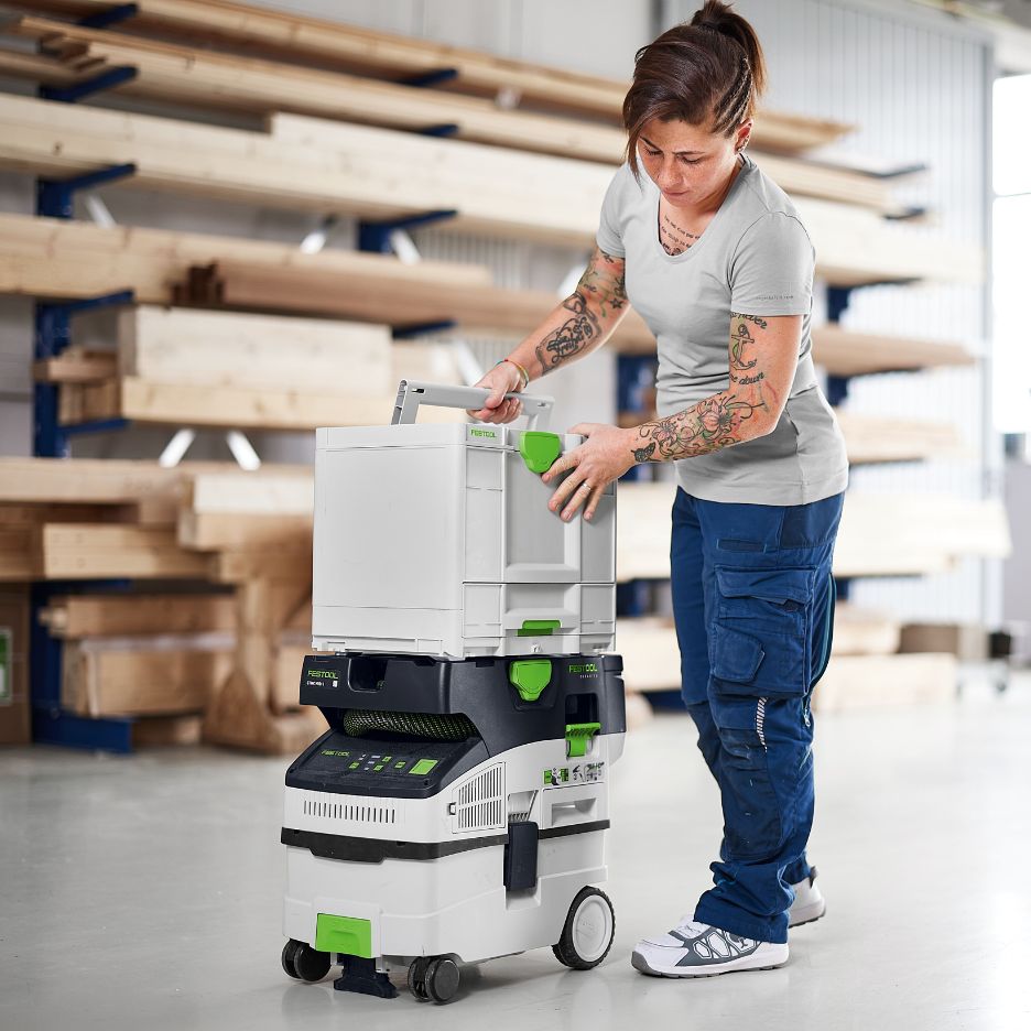 Woman securing Festool Systainer SYS3-COMBI M 337 on top of transport trolley