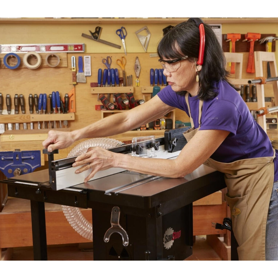 Woman adjusting the fence assembly in the SawStop Standalone Router Table