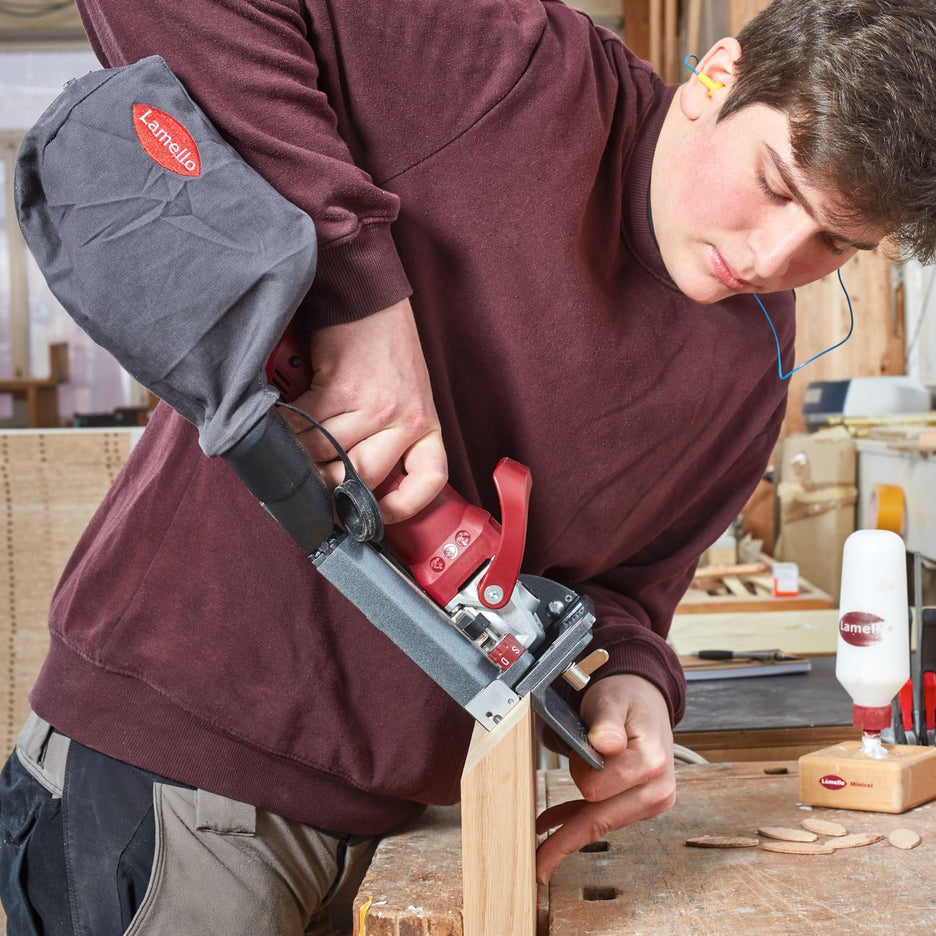 Woodworker uses Lamello Classic X Cordless Biscuit Joiner to join mitred parts.